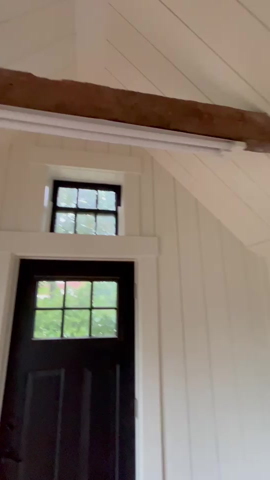 Shiplap ceiling, wood beam and entry trim.