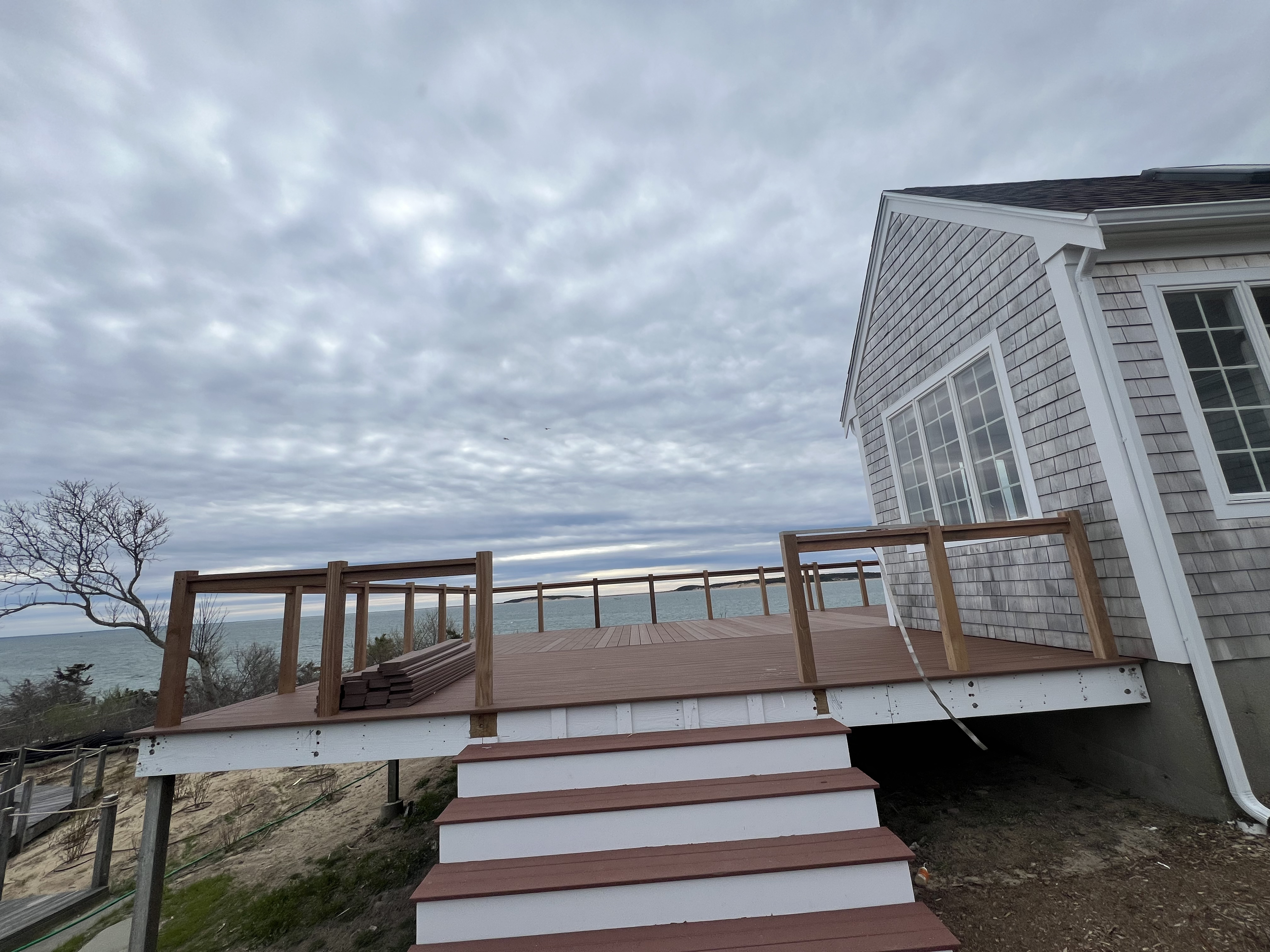 Deck stairs and wood posts with cable railing.