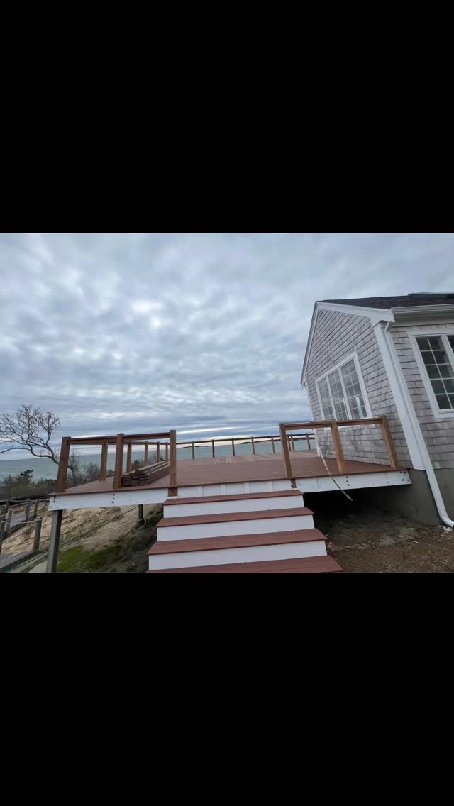 Deck stairs and wood posts with cable railing.