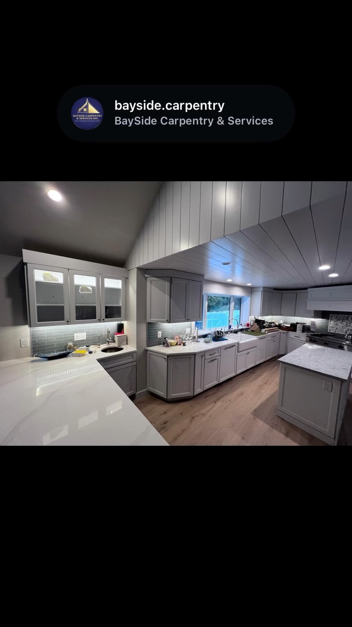 Kitchen cabinetry and ceiling paneling.