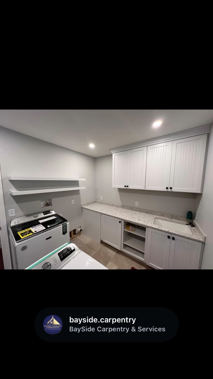 Laundry room cabinets, counter space and floating shelves.